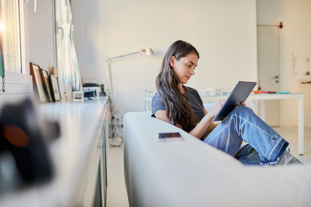 Young woman using tablet to speak with therapist